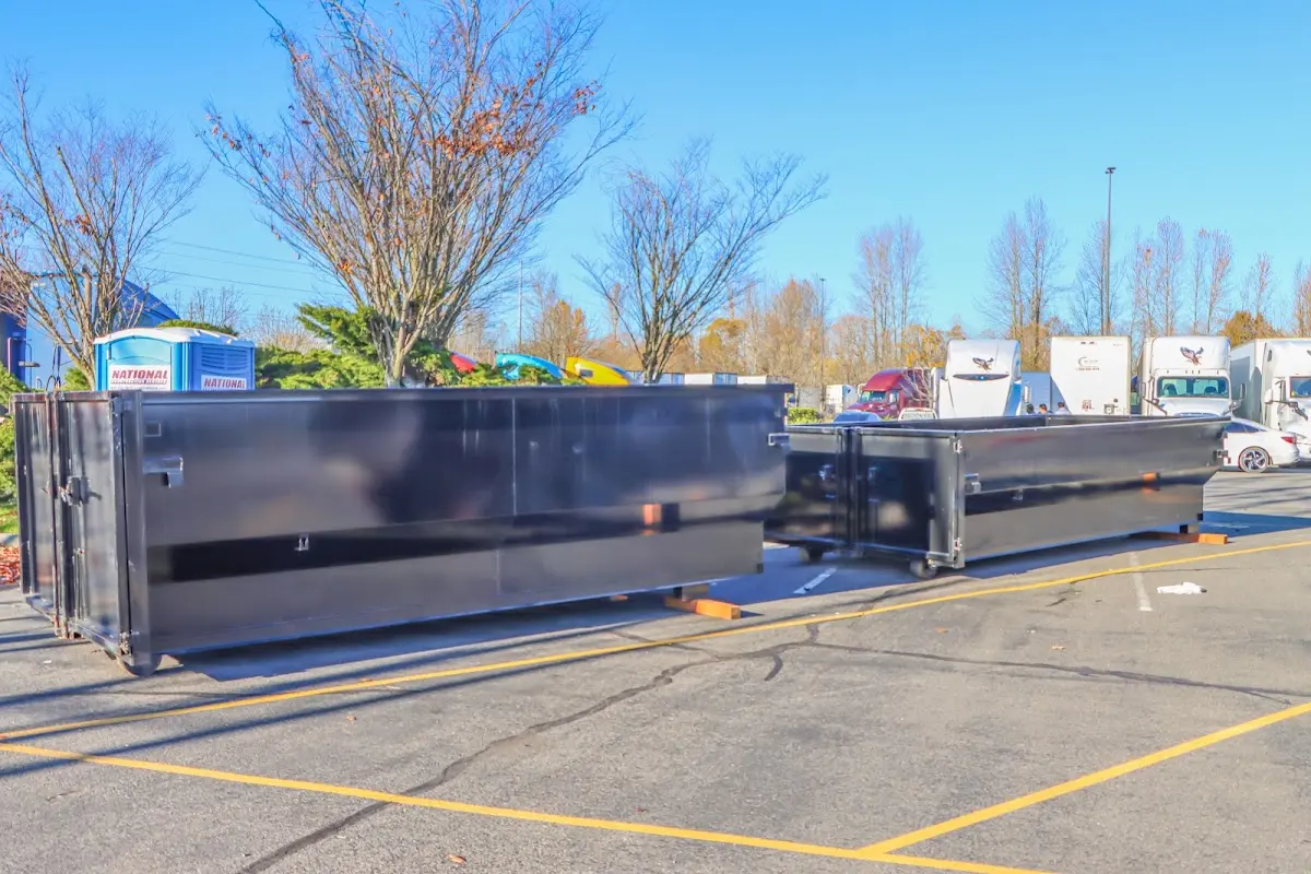 Professional dumpster rental service with roll-off container on residential driveway in Palmetto Estates